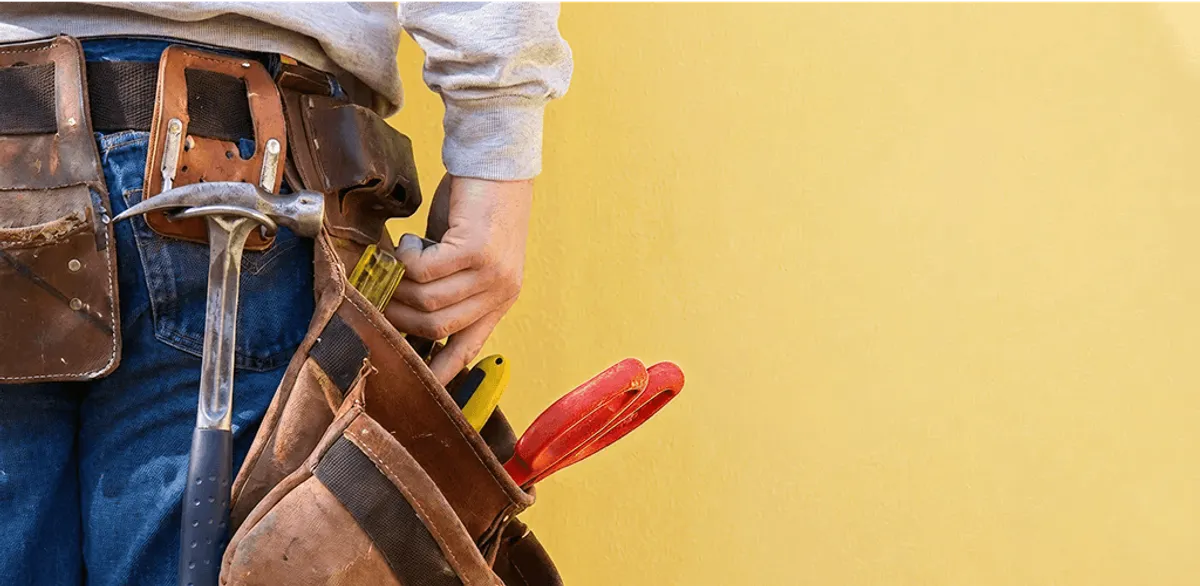 Handyman with tool belt ready for home repairs and maintenance in Albuquerque, NM
