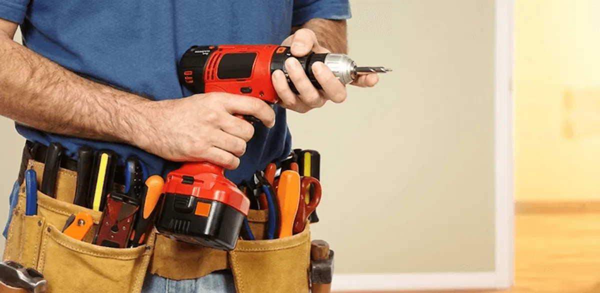 Handyman holding a power drill for home repairs and installations in Albuquerque, NM